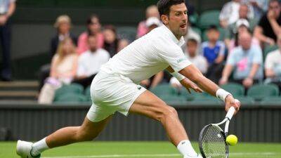 Top seed Djokovic into Wimbledon 2nd round with 80th career win at All England Club