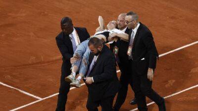 Protester ties herself to the net to interrupt French Open semi-final