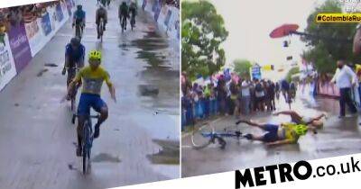 Cyclist crashes into wife taking pictures of him as he crossed line - metro.co.uk - Colombia