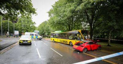 Major road shut after smash between school bus and sports car - latest updates