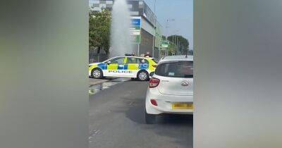 Moment water shoots into the air as 'vandals' set off fire hydrant on busy Manchester road - manchestereveningnews.co.uk - Manchester