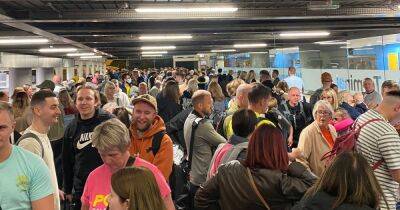 'Utter shambles' at chaos-hit Manchester Airport as queues stretch back to the CAR PARK
