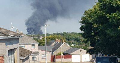 Live updates as fires close roads and send black smoke billowing into the air