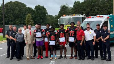 Georgia high school football players named honorary first responders after saving woman in car wreck