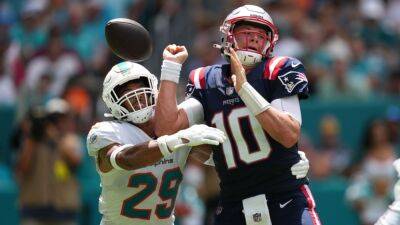 New England Patriots' Mac Jones not made available to media after suffering back injury in loss to Miami Dolphins