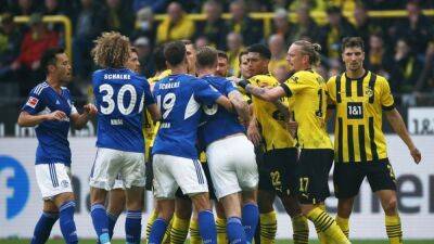 Moukoko goal sends Dortmund top, Reus injured