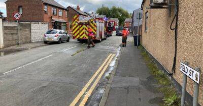 Major road closed as man rescued from flat fire