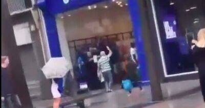 Celtic fan celebrates derby demolition with sing song OUTSIDE the Rangers store