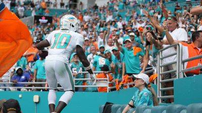 Tyreek Hill surprises fan with signed Dolphins gear after viral touchdown ball mix-up