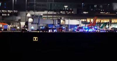 Police and fire crews swarm Manchester Airport runway after report of suspicious package on plane