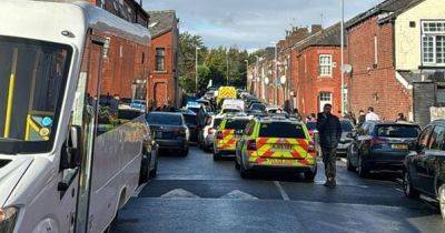 12-year-old boy and a woman injured in dog attack in Oldham as person arrested