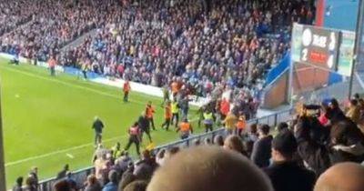 Police investigating after footage shows fans piling onto pitch and fighting during Rochdale v Oldham game