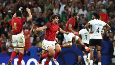 Portugal claim first World Cup win, but Fiji reach quarters