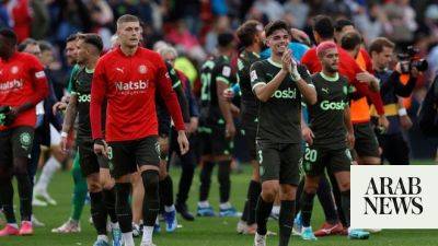 Girona wins again to keep Spanish league lead after 2-1 comeback at Rayo