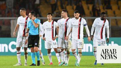 AC Milan again let slip a two-goal lead in a 2-2 draw at Lecce, Juventus beat Cagliari to go top