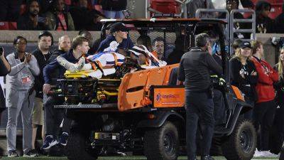 Virginia running back undergoes spinal surgery after leaving game on stretcher
