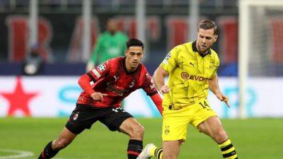 Dortmund reach Champions League last 16 with 3-1 win at Milan