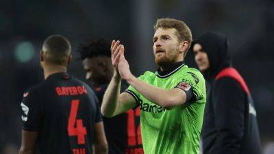 Leverkusen down Frankfurt 3-0 to stay four points clear at the top
