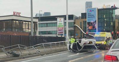 LIVE: Huge delays on busy Manchester road as car OVERTURNS near Asda - latest updates