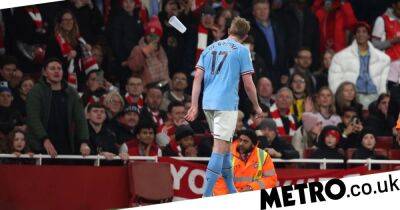‘Beer, anyone?’ – Kevin de Bruyne mocks Arsenal fans after being pelted by plastic bottles and glasses following Man City win
