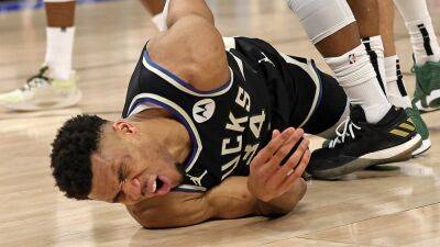 Bucks' Giannis Antetokounmpo forced out of playoff game after hard fall on back