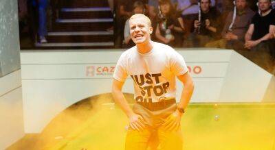 'Just Stop Oil' protester cancels world snooker championship after pouring orange dye on table
