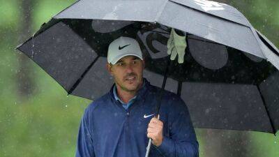 Brooks Koepka leads by four as Masters suspends play for day