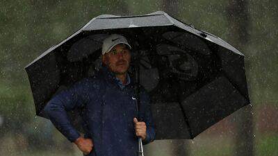 Masters third round suspended until Sunday due to inclement weather; leaders expected to play 30 holes Sunday