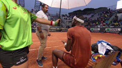 Italian Open: Frances Tiafoe unhappy as match with Lorenzo Musetti continues in rain - 'How are we possibly playing?'
