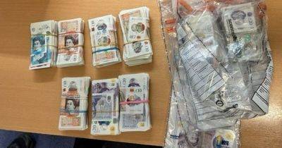 Huge wads of cash found in 'suspicious vehicle' as two men arrested