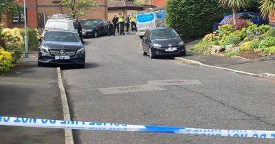 Cordon in place with residents unable to leave after men armed with weapons storm street