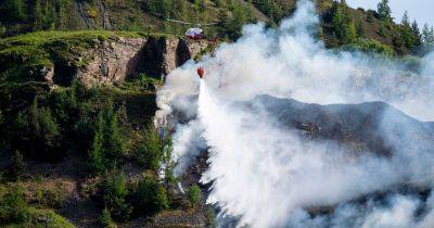 Live updates as mountain fire sees helicopter deployed to douse flames