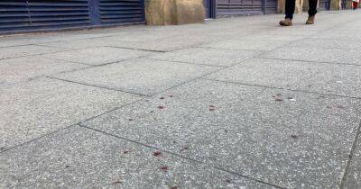 The blood splattered pavement which shows the violence on Deansgate last night