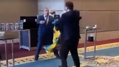Watch: Ukrainian MP punches Russian politician in the head after flag stunt