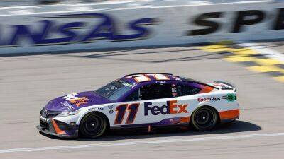 Denny Hamlin nudges Kyle Larson into the wall on final lap to take lead and win at Kansas
