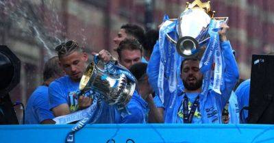 Rain and threat of lightning fail to dampen Manchester City’s trophy parade