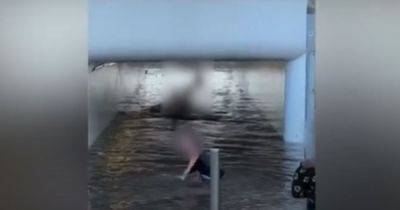 Moment kids SWIM in flooded underpass as water bursts from street hydrant - manchestereveningnews.co.uk - county Cross - county Lane