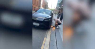 Moment man filmed cutting clamp off Lamborghini with angle grinder in Manchester city centre