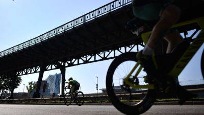 Motorcycle rider dies in crash with cyclist at Ironman race - ESPN
