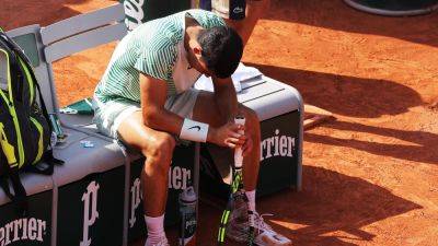 French Open: Fans boo as Carlos Alcaraz forced to forfeit game after attack of cramp against Novak Djokovic