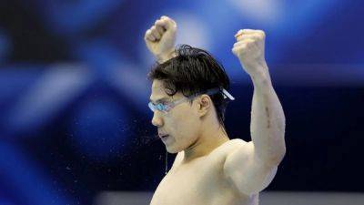 China's Qin smashes record for breaststroke hat-trick at worlds