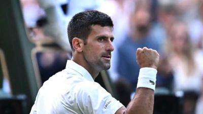 Wawrinka sets up Djokovic clash as Wimbledon clears backlog