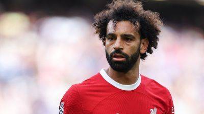Liverpool's Mo Salah appears unhappy after getting subbed off in Premier League opener