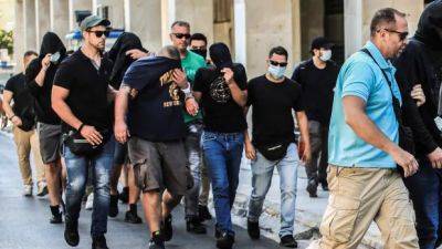 Greek authorities order 105 soccer fans to be detained pending trial after fatal clash