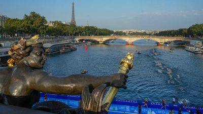 World's top female triathletes swim in Paris' Seine River ahead of next year's Paris Olympics