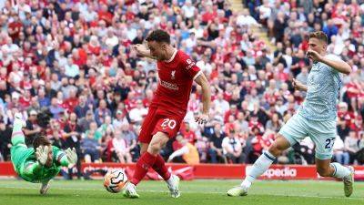 Ten-man Liverpool dig deep to beat Bournemouth