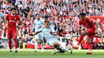 Ten-man Liverpool beat Bournemouth, Brighton go top of Premier League