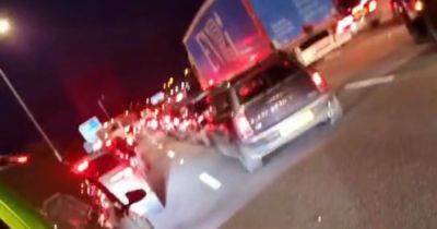 'Chaos' on motorway with roads closed by police after huge car meet moves across Manchester