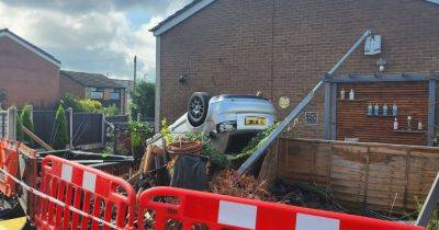 'It could easily have killed us'...Horror as Audi ploughs into garden during police chase and 'pins' teen under car