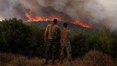 Greek fire officials arrest two for arson as multiple wildfires rage